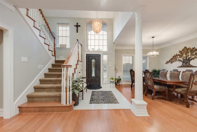 537 Estate Dr, Grand Prairie, TX 75052 - entryway featuring a chandelier, decorative columns, stairway, wood finished floors, and healthy amount of natural light
