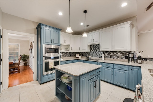 537 Estate Dr, Grand Prairie, TX 75052 - kitchen with stainless steel appliances, open shelves, blue cabinets, light tile patterned floors, and recessed lighting