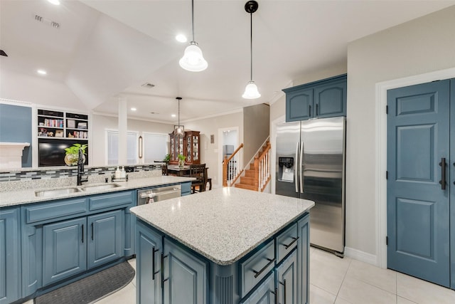 537 Estate Dr, Grand Prairie, TX 75052 - kitchen featuring stainless steel appliances, blue cabinets, tasteful backsplash, a kitchen island, and light stone counters