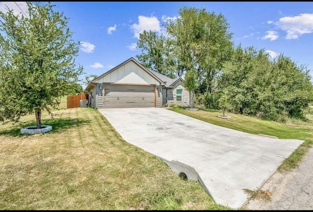 2608 San Gabriel Dr, Granbury, TX 76048 - view of front of property with board and batten siding, an attached garage, and concrete driveway