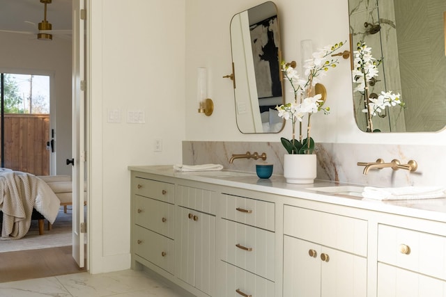 3815 Dunhaven Rd, Dallas, TX 75220 - bathroom featuring ensuite bathroom, marble finish floors, double vanity, and decorative backsplash