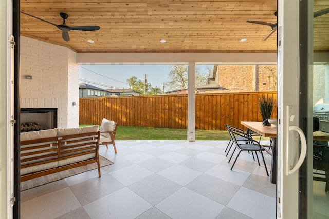 3815 Dunhaven Rd, Dallas, TX 75220 - fenced backyard featuring an outdoor living space with a fireplace, outdoor dining area, a patio area, and ceiling fan