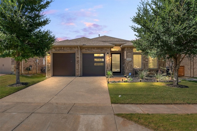 15321 Mount Evans Dr, Little Elm, TX 75068 - view of front facade featuring concrete driveway, an attached garage, a lawn, brick siding, and a shingled roof