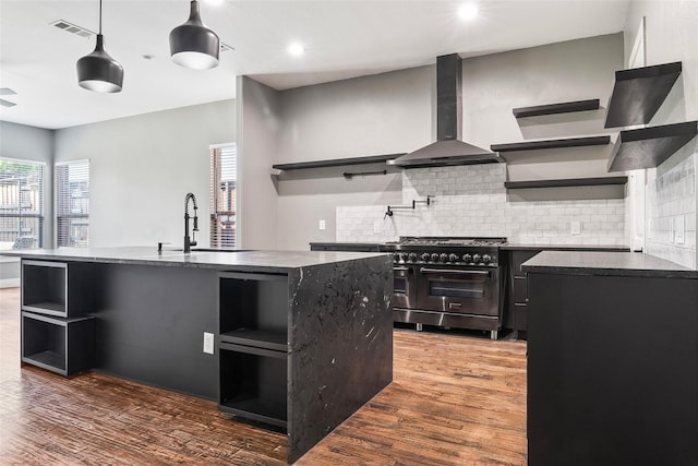 15321 Mount Evans Dr, Little Elm, TX 75068 - kitchen with open shelves, wall chimney range hood, double oven range, healthy amount of natural light, and recessed lighting
