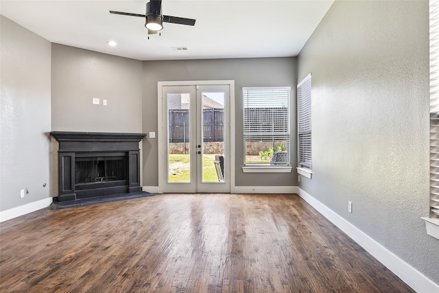15321 Mount Evans Dr, Little Elm, TX 75068 - unfurnished living room featuring french doors, a ceiling fan, wood finished floors, a fireplace with raised hearth, and a textured wall