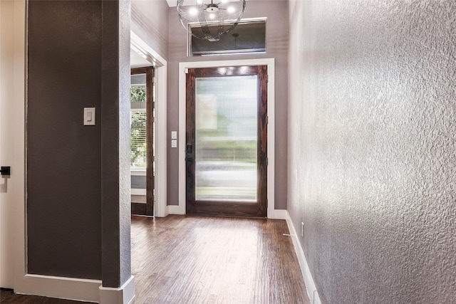15321 Mount Evans Dr, Little Elm, TX 75068 - foyer with a textured wall, wood finished floors, and a chandelier
