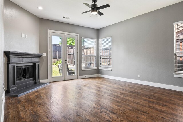15321 Mount Evans Dr, Little Elm, TX 75068 - unfurnished living room with a ceiling fan, french doors, wood finished floors, a fireplace with raised hearth, and recessed lighting