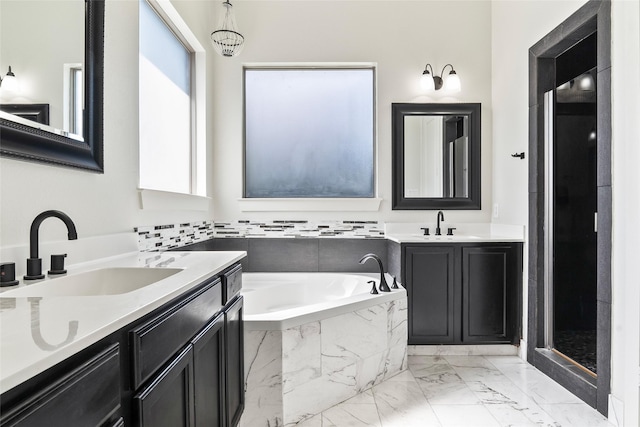 15321 Mount Evans Dr, Little Elm, TX 75068 - bathroom featuring marble look tiles, two vanities, and a bath