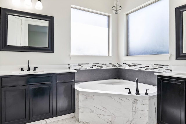 15321 Mount Evans Dr, Little Elm, TX 75068 - bathroom with two vanities, marble look tiles, and a bath