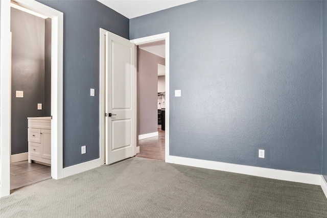 15321 Mount Evans Dr, Little Elm, TX 75068 - unfurnished bedroom featuring carpet floors, ensuite bathroom, and a textured wall