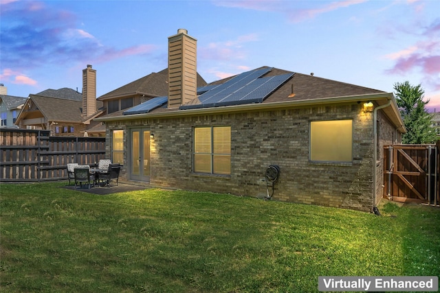 15321 Mount Evans Dr, Little Elm, TX 75068 - back of property featuring a fenced backyard, solar panels, a chimney, and a patio area