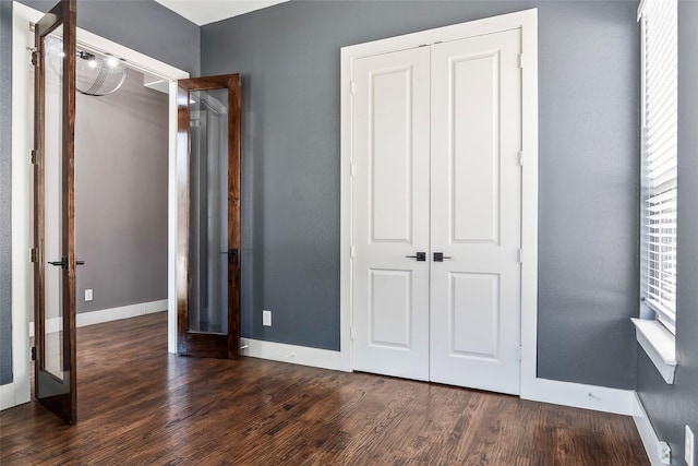 15321 Mount Evans Dr, Little Elm, TX 75068 - unfurnished bedroom featuring wood finished floors, a closet, and multiple windows