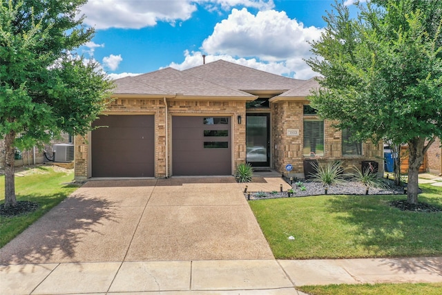 15321 Mount Evans Dr, Little Elm, TX 75068 - view of front of house featuring an attached garage, driveway, roof with shingles, a front lawn, and brick siding