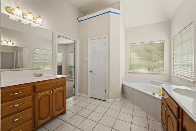 1036 E Oaklawn Dr, Talty, TX 75160 - full bathroom featuring two vanities, tile patterned floors, and a garden tub
