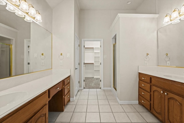 1036 E Oaklawn Dr, Talty, TX 75160 - bathroom featuring a stall shower, two vanities, a walk in closet, and tile patterned flooring