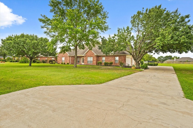 1036 E Oaklawn Dr, Talty, TX 75160 - view of front of home featuring driveway, a front yard, and brick siding