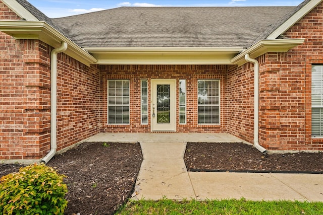 1036 E Oaklawn Dr, Talty, TX 75160 - entrance to property with brick siding, a shingled roof, and a patio
