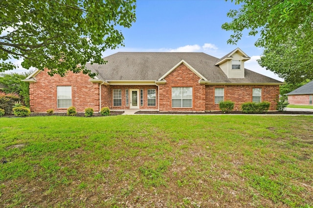 1036 E Oaklawn Dr, Talty, TX 75160 - view of front of house featuring brick siding, a front lawn, and roof with shingles