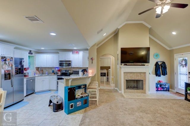 189 Bent Tree Loop, Haughton, LA 71037 - kitchen featuring appliances with stainless steel finishes, independent washer and dryer, a breakfast bar area, a ceiling fan, and white cabinetry
