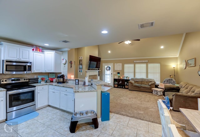 189 Bent Tree Loop, Haughton, LA 71037 - kitchen featuring stainless steel appliances, a peninsula, light tile patterned floors, light colored carpet, and open floor plan