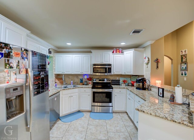 189 Bent Tree Loop, Haughton, LA 71037 - kitchen with appliances with stainless steel finishes, backsplash, arched walkways, a peninsula, and crown molding