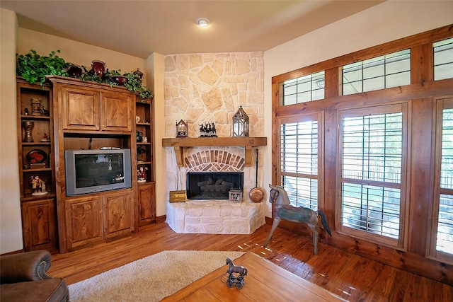 1702 High Point Dr, Pilot Point, TX 76258 - living area with a stone fireplace and light wood finished floors