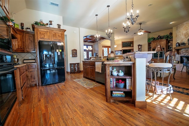 1702 High Point Dr, Pilot Point, TX 76258 - kitchen featuring black appliances, wood finished floors, ceiling fan, and arched walkways