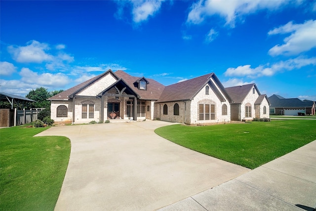 1702 High Point Dr, Pilot Point, TX 76258 - french country home with brick siding, concrete driveway, a front lawn, and stone siding