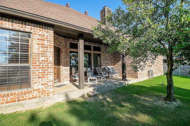 1702 High Point Dr, Pilot Point, TX 76258 - back of house with brick siding, a chimney, and a patio