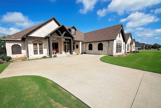 1702 High Point Dr, Pilot Point, TX 76258 - french country home with stone siding, roof with shingles, and a front yard