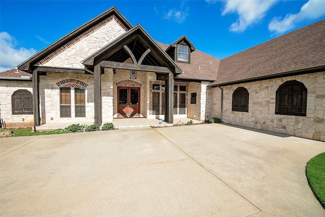 1702 High Point Dr, Pilot Point, TX 76258 - french country style house featuring stone siding and a shingled roof