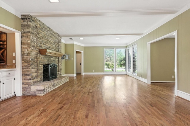 9901 Burnham Dr, Dallas, TX 75243 - unfurnished living room featuring a brick fireplace, wood finished floors, crown molding, and beam ceiling