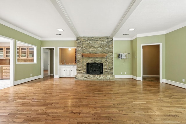 9901 Burnham Dr, Dallas, TX 75243 - unfurnished living room with wood finished floors, crown molding, and a brick fireplace
