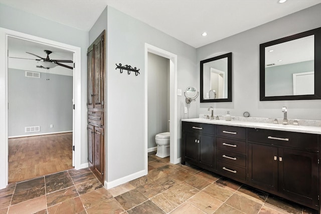 9901 Burnham Dr, Dallas, TX 75243 - full bath featuring double vanity, a ceiling fan, stone finish flooring, and recessed lighting