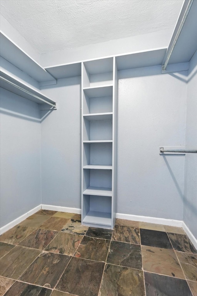 9901 Burnham Dr, Dallas, TX 75243 - walk in closet with stone finish flooring
