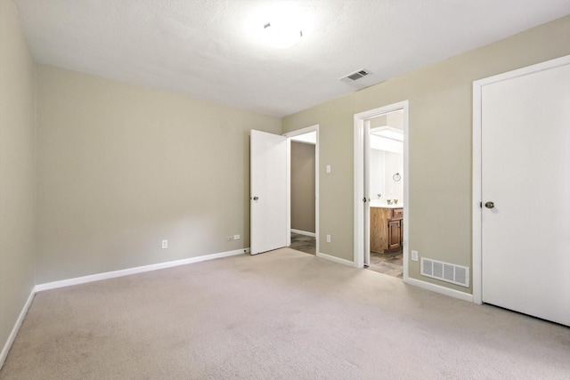 9901 Burnham Dr, Dallas, TX 75243 - unfurnished bedroom with carpet flooring and ensuite bathroom