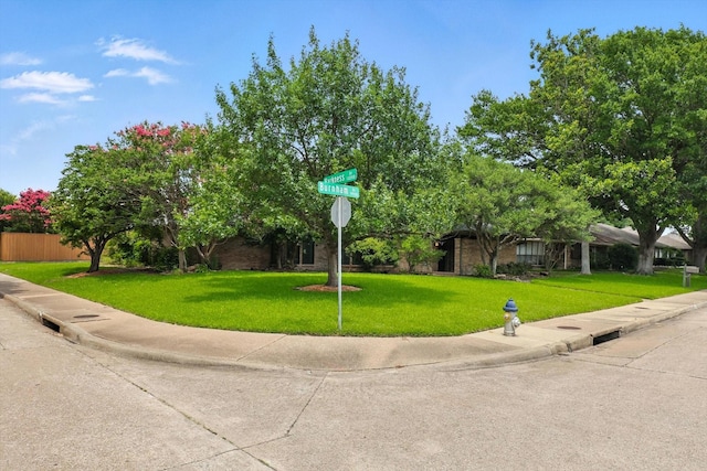 9901 Burnham Dr, Dallas, TX 75243 - surrounding community featuring a lawn