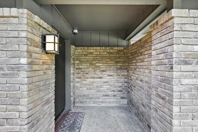 9901 Burnham Dr, Dallas, TX 75243 - doorway to property with brick siding and a security system