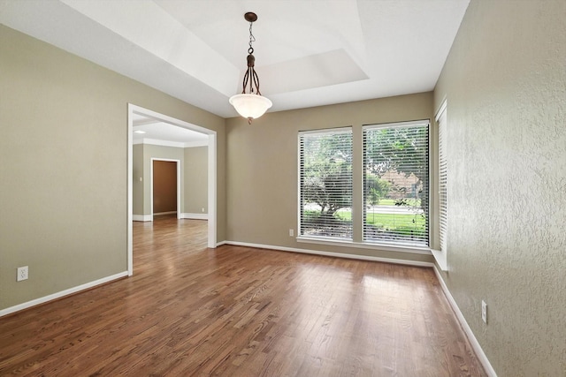 9901 Burnham Dr, Dallas, TX 75243 - unfurnished room featuring wood finished floors and a textured wall