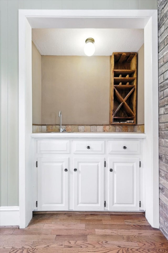 9901 Burnham Dr, Dallas, TX 75243 - indoor wet bar with light wood finished floors