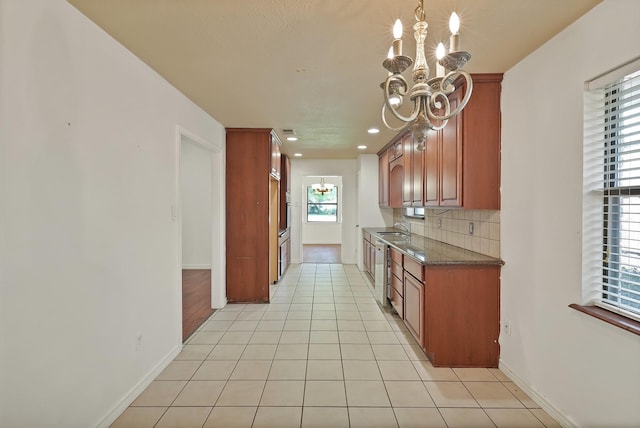 4949 Mill Run Rd, Dallas, TX 75244 - kitchen with a chandelier, light tile patterned floors, backsplash, recessed lighting, and brown cabinets
