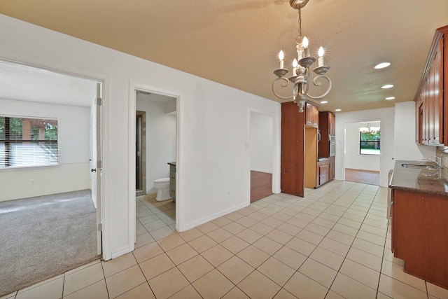 4949 Mill Run Rd, Dallas, TX 75244 - kitchen with a chandelier, recessed lighting, light tile patterned floors, hanging light fixtures, and white oven