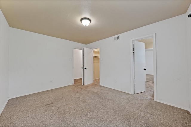 4949 Mill Run Rd, Dallas, TX 75244 - unfurnished bedroom featuring carpet flooring and a walk in closet
