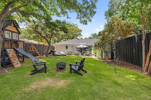 1106 Pueblo Dr, Richardson, TX 75080 - fenced backyard with a playground, a fire pit, and a patio area