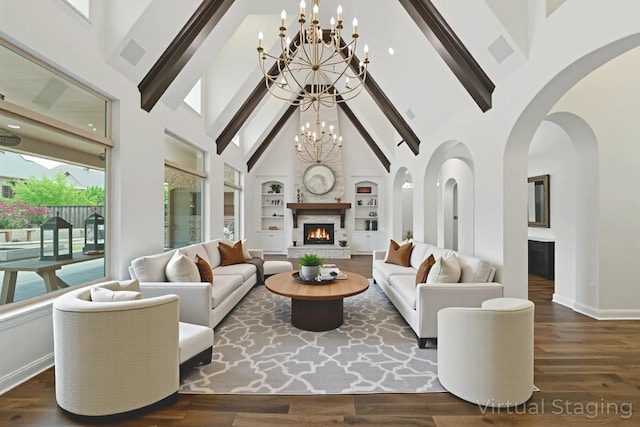 4510 Woodbine Ln, Prosper, TX 75078 - living area with a warm lit fireplace, a chandelier, high vaulted ceiling, built in shelves, and beam ceiling
