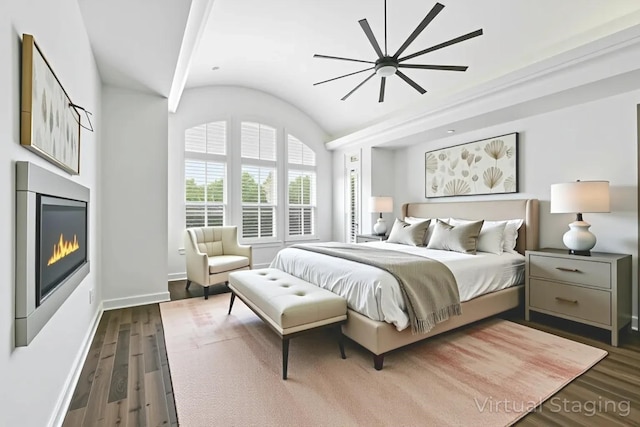 4510 Woodbine Ln, Prosper, TX 75078 - bedroom featuring dark wood-type flooring, vaulted ceiling, a glass covered fireplace, and a ceiling fan