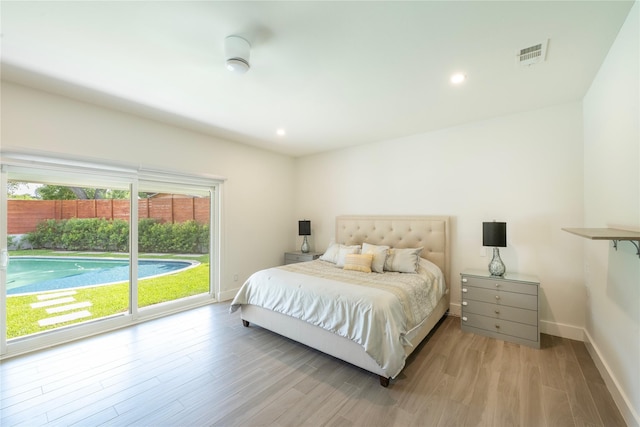 6956 Meadowbriar Ln, Dallas, TX 75230 - bedroom featuring light wood-style flooring, access to exterior, and recessed lighting