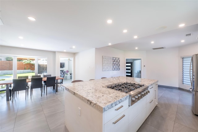 6956 Meadowbriar Ln, Dallas, TX 75230 - kitchen featuring stainless steel appliances, a kitchen island, white cabinets, modern cabinets, and recessed lighting