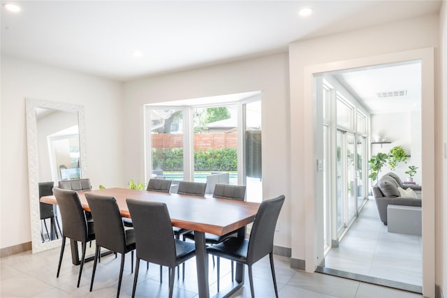 6956 Meadowbriar Ln, Dallas, TX 75230 - dining space with light tile patterned floors and recessed lighting