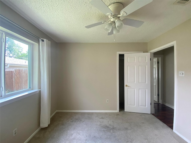 2225 Shady Brook Dr, Bedford, TX 76021 - unfurnished bedroom with carpet, a textured ceiling, and ceiling fan